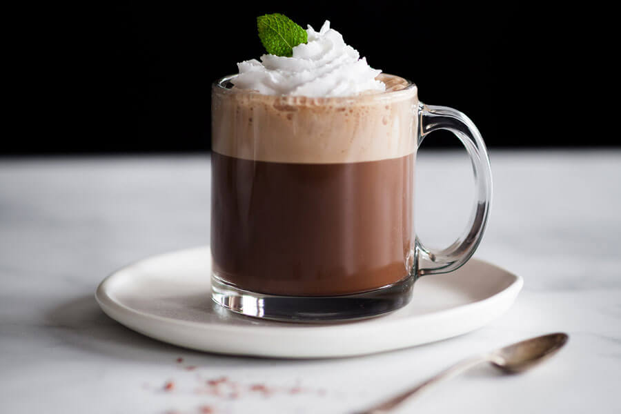 Cafe moka de menta en una taza de cristal decorado con nata